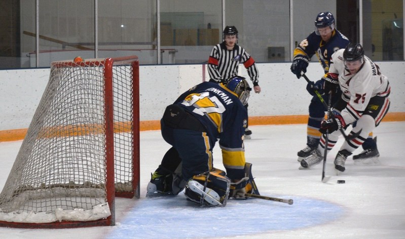 Innisfail Eagles forward Pete Vandermeer takes the puck to the net, setting up Ryan Caswell for the team&#8217;s third goal of the game against the Stony Plain Eagles on