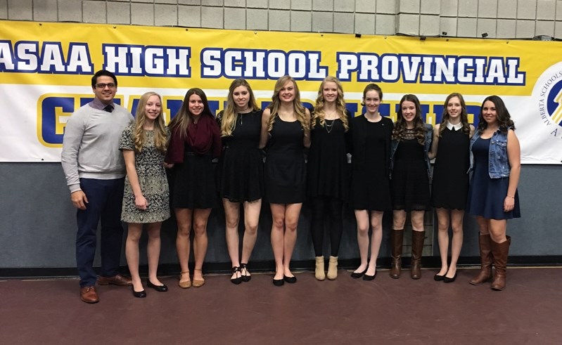 Head coach Deen Lockhat in Camrose with nine members of Innisfail High School&#8217;s senior girls volleyball team at the 2016 3A Girls Provincial Championship.