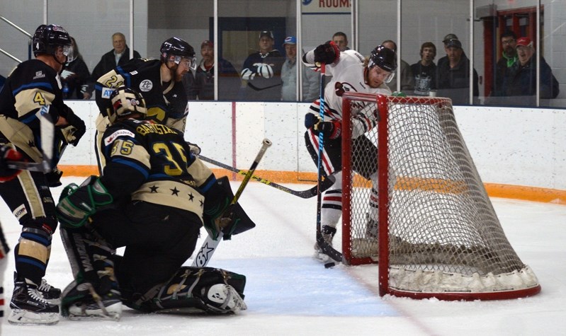 Innisfail Eagles forward Tom Mikrut tries to control the puck at the Generals&#8217; net during a game Friday at the Innisfail Arena. The Lacombe Generals took the game 5-1.