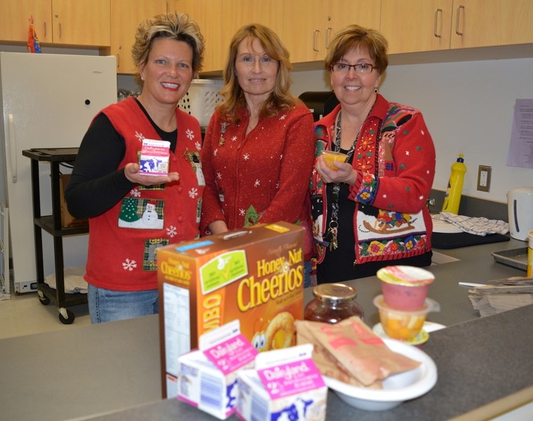 The new breakfast program at St. Marguerite Bourgeoys Catholic School Monday to Wednesday is helping feed and nourish students. From left are breakfast program volunteer Lisa 