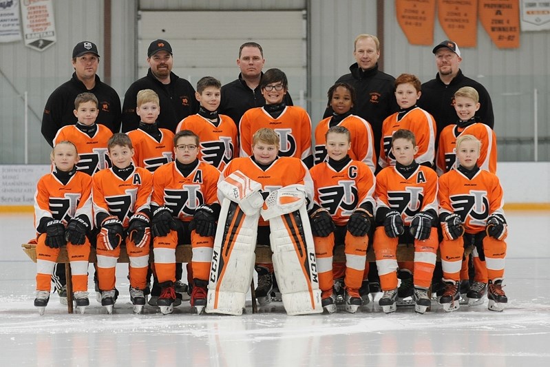 The Innisfail Atom A DQ Flyers pose for a group photo after winning their annual home tournament with a well-fought 6-3 battle against the Bow River Bruins on Dec. 11.