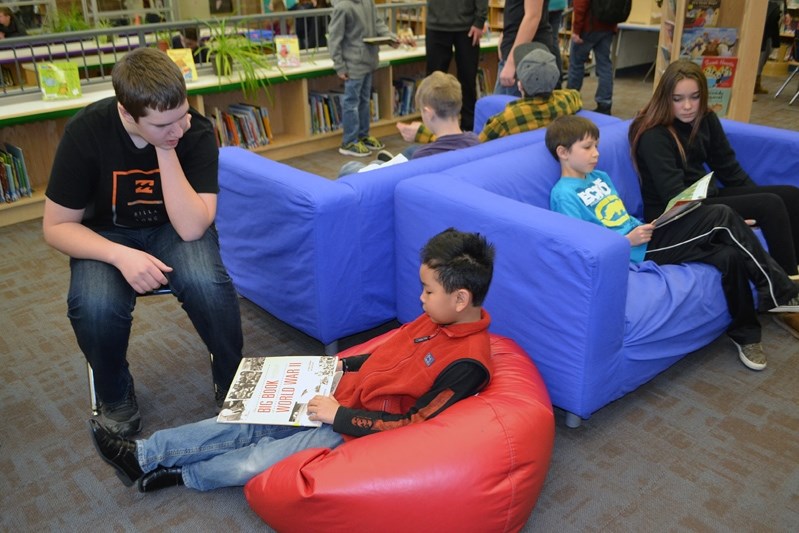 Older students settle down in the morning to buddy up with the young ones and to enjoy a half hour of reading.