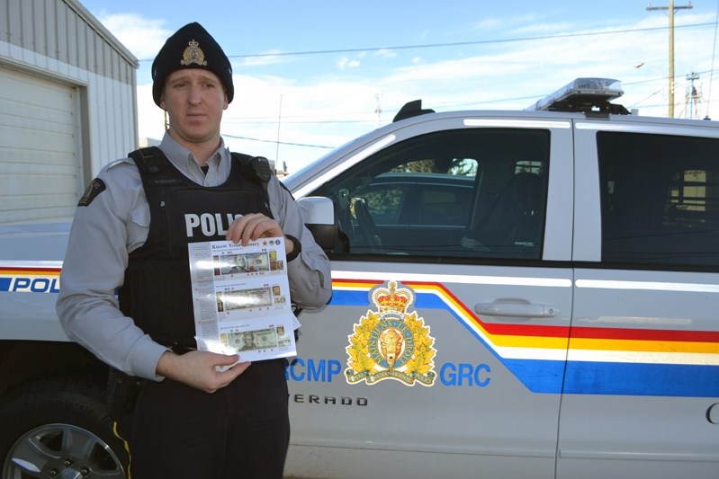 Innisfail RCMP Const. Simon Watson began his counterfeit money campaign last month and will visit local businesses to provide advice, tips and brochures on how to identify