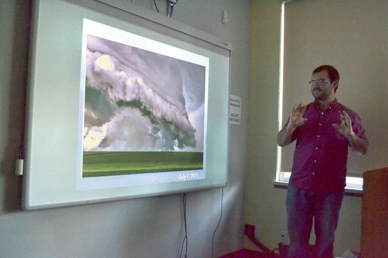 Storm chaser Brian Constantine of Twisted Chasers checks out a photo of a storm.