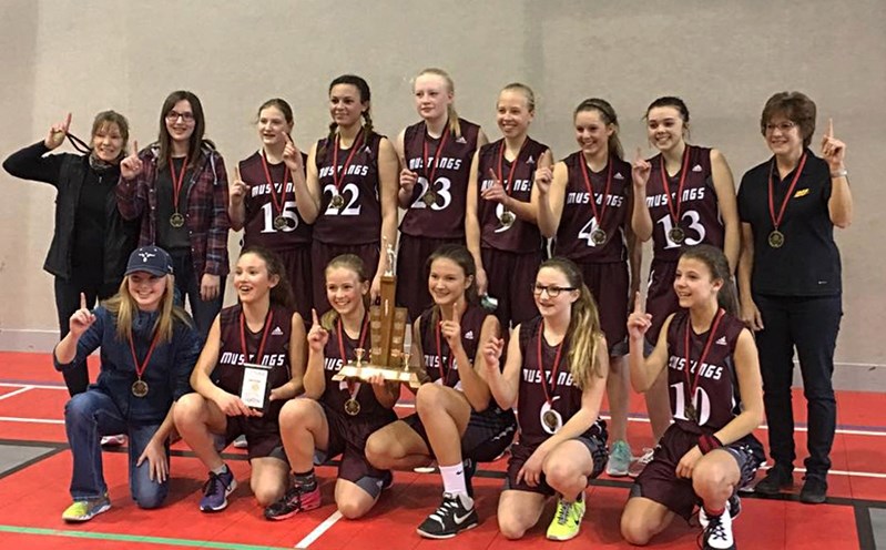 The CENAA A junior high girls&#8217; basketball team proudly show off their gold medals after taking the league championship title in a tournament March 4 in Red Deer.