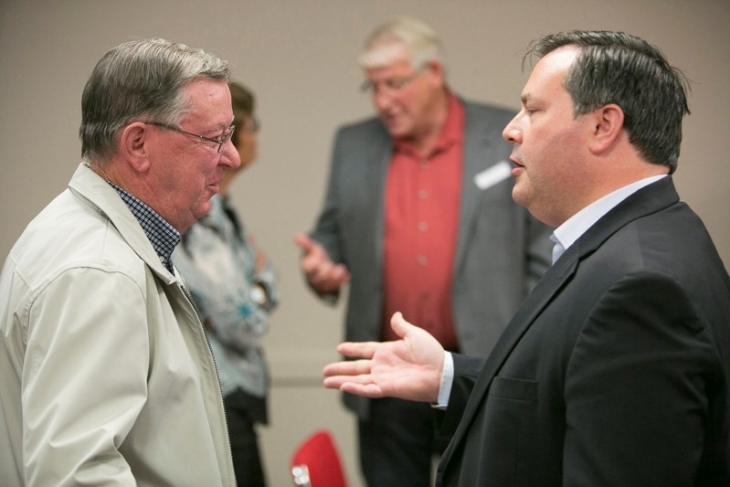 Jason Kenney, right, speaks with former Olds-Didsbury-Three Hills MLA Bruce Rowe during last fall&#8217;s Olds-Didsbury-Three Hills PC party annual general meeting at the