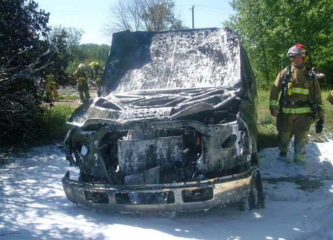 Penhold firefighters examine the scene of a recent truck fire.