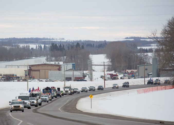 Big rigs head out along Highway 54 at the start of the convoy to Olds.