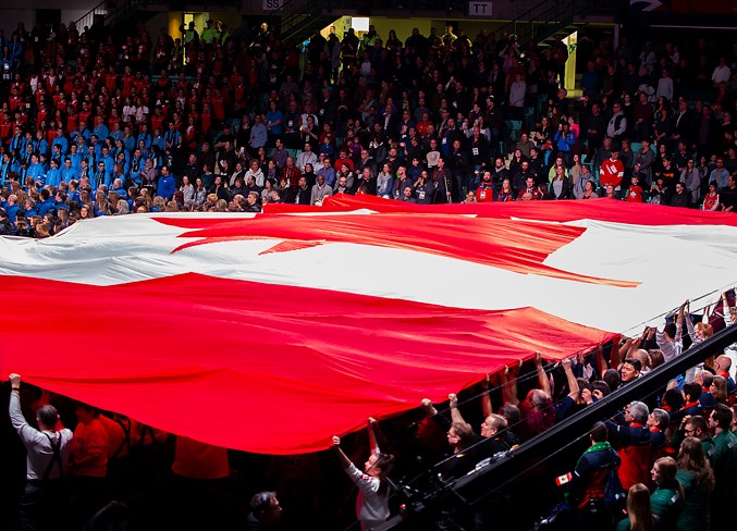  The Canada flag is held up by Games opening ceremony participants.