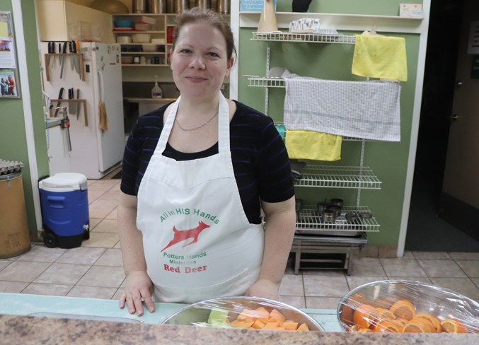  Volunteer soup kitchen manager Amanda Oster loves when Ivan Daines sings a song for her on Saturday mornings.