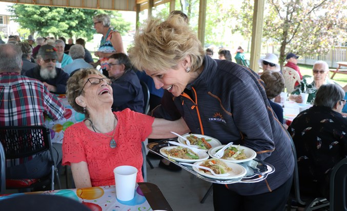 Seniors Jean Barclay serving