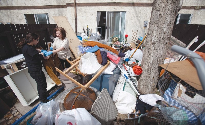 Paul Davis Systems workers pack up a resident&#8217;s belongings on May. 2 from a townhouse at Braeburn Estates that was flooded April 26.