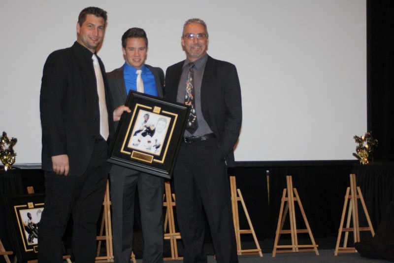 Dylan Hubbs (middle), was presented with the Olds Grizzlys&#8217; playoff MVP award on Saturday during the team&#8217;s annual banquet. Assistant coach Brett Hopfe (left) and 