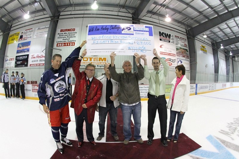 Members of local victims services foundations accept a cheque for $83,000 after the third annual Wild Rose Hockey Challenge, Aug. 27 at the Spray Lakes Sawmills Recreation