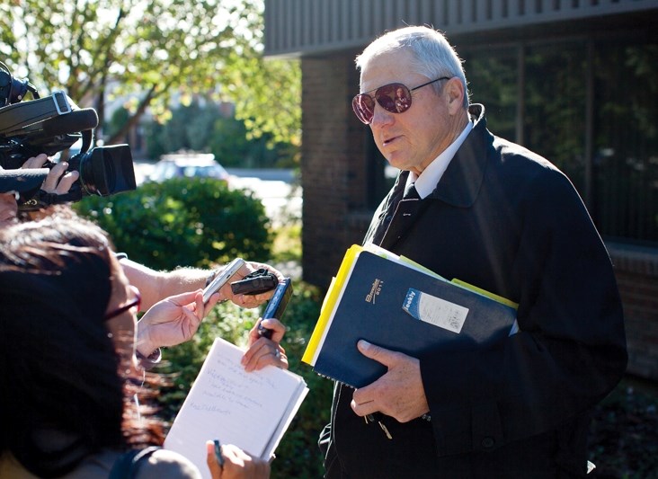 Roy Shellnut, defense lawyer for Andrea Strang who is the accused in a July 26 Akita dog attack, answers questions from the media outside the Didsbury Provincial court