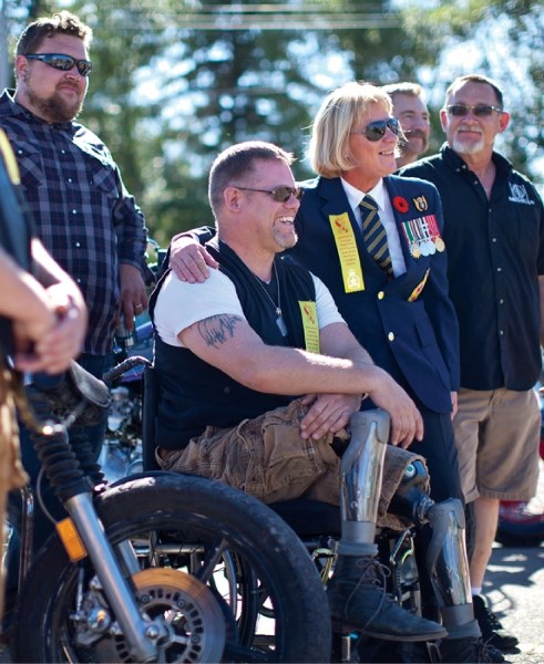 Retired Master Cpl. Paul Franklin, middle, and retired Sergeant Leslie Manchur pose for a photo during a barbecue lunch at the Olds Legion last Saturday.