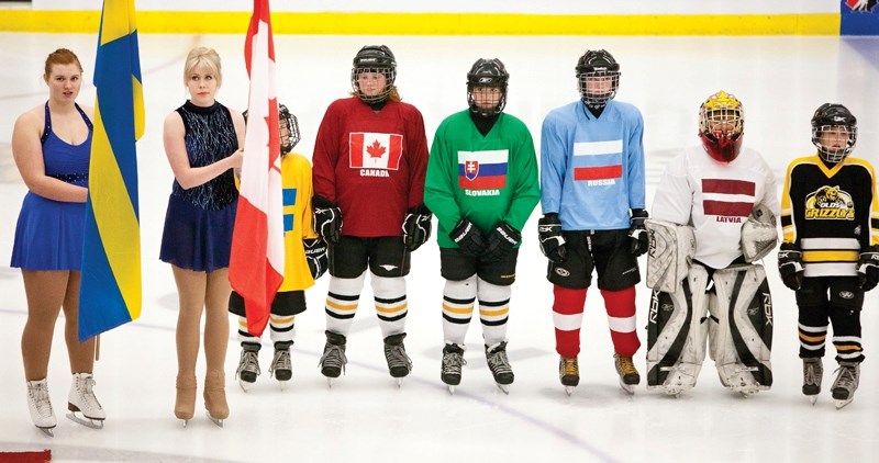 A group of children representing the different countries taking part in the World Junior Championship lines up at the start of the Team Denmark versus Team Sweden game.