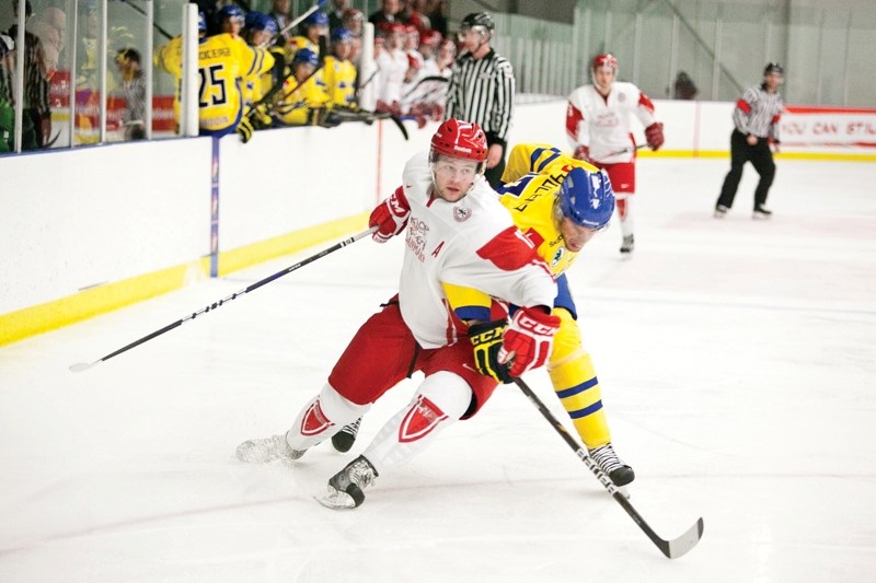 A Team Denmark and a Team Sweden player jockey for position during their pre-tournament game at the Olds Sportsplex last Tuesday.