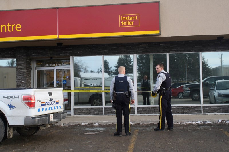 RCMP officers cordon off the CIBC at 4513 52 Ave. in Olds after a robber escaped from the branch with an undisclosed amount of money.