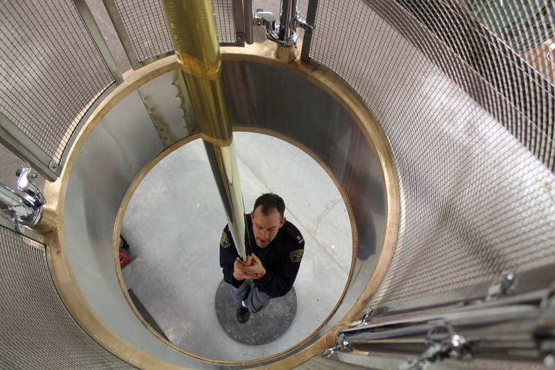 Olds Fire Department member Jason Holloway slides down the fire pole at the department&#8217;s new home at the recently completed Olds emergency services building on 65