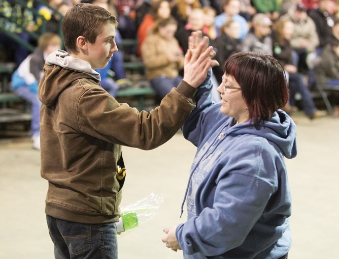 Garret Crawford, left, receives an award during a 4-H multi-judging event at the Cow Palace on Jan. 4.