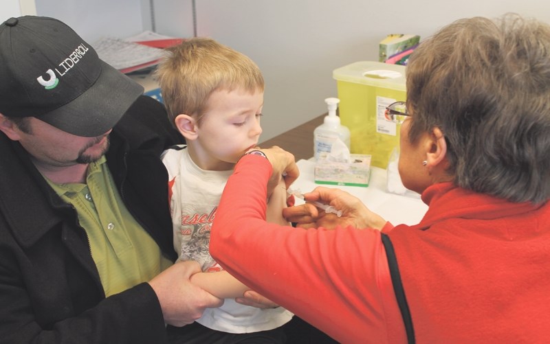 Jeremy Lutz, four, proved just how tough he is when he received his influenza vaccination at the Olds Community Health Centre on the morning of Jan. 6. Nurse Pauline Parlee