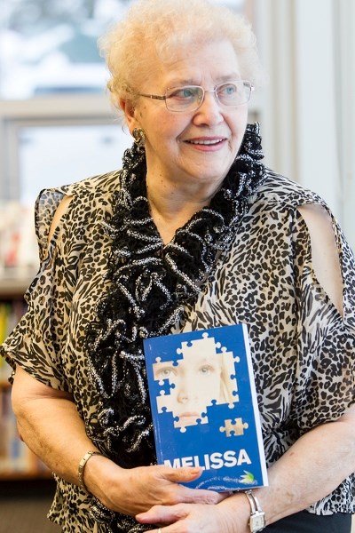 Millie Mytton with a copy of her book Melissa at the Olds Municipal Library on Jan. 7. CLICK ON PICTURE TO ENLARGE PHOTOGRAPH.