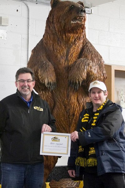 Russell Jemieff (left), president of the Olds Grizzlys&#8217; board of directors, hands over the first season tickets package to Ben Fuller of Didsbury on Jan. 31. The team