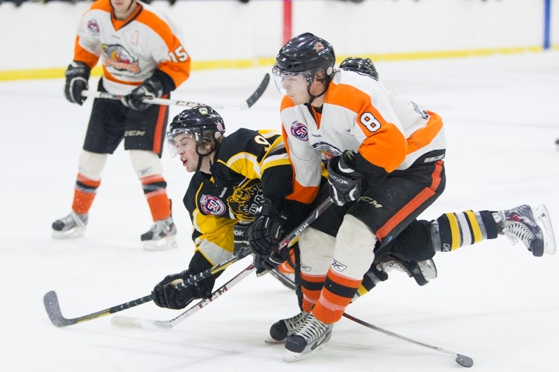 Olds Grizzlys player Chris Gerrie collides with a Drumheller Dragons player during their game at the Olds Sports Complex on Jan. 31. The Dragons won the game 3-2 in overtime.