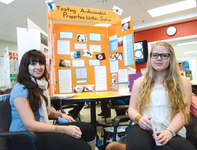 Olds High School Grade 10 students Janine Nel, left, and Taylor Ormann with their project at the Mountainview Science and Technology Society Science Fair at Olds High School