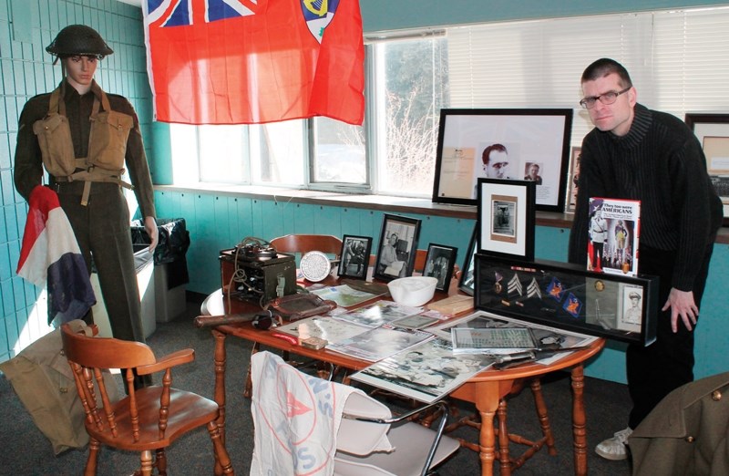 Andrew Kelly stands among just a small sample of Second World War relics he has collected over the years. He will showcase his collection at Olds College&#8217;s Frank