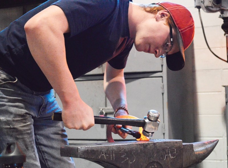 Marshall Pagenkopf, an Olds College student, is applying for a farrier position with the RCMP Musical Ride. Here, he&#8217;s working on a horseshoe on Feb. 28.