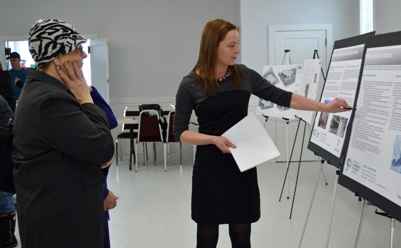 (From left) Olds mayor Judy Dahl watches as Jolene Tejkl of Parkland Community Planning Services briefs her on the East Olds Redevelopment Plan. The two were at an open house 