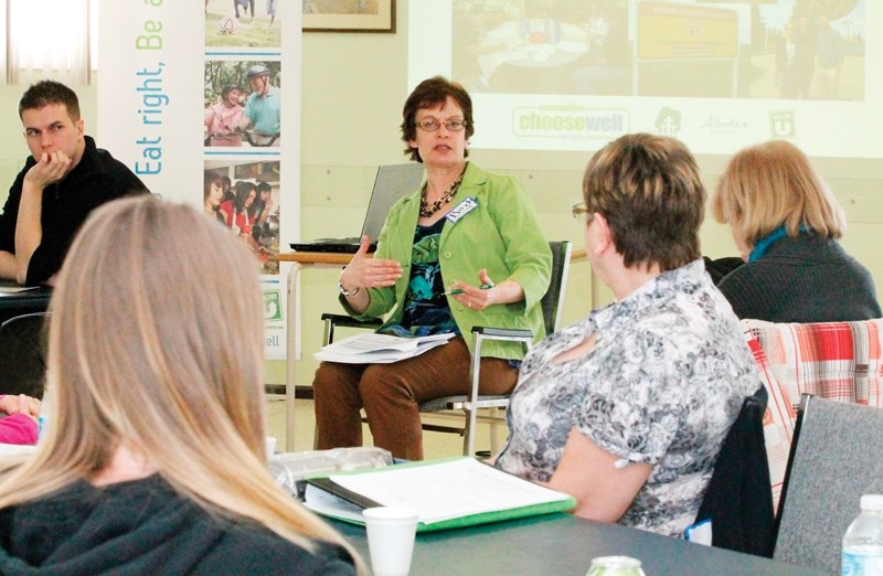 Facilitator Barb Pedersen leads a discussion on topics such as how to attract people to take part in community events focused on healthy living during the 2014 Communities