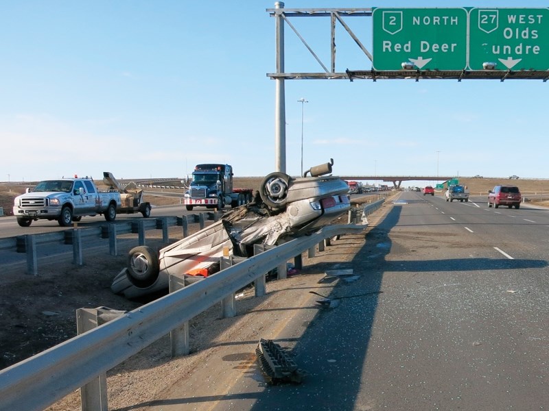 Police say they planning to ticket drivers who took pictures with their cellphones of this rollover on Highway 2 on April 11.