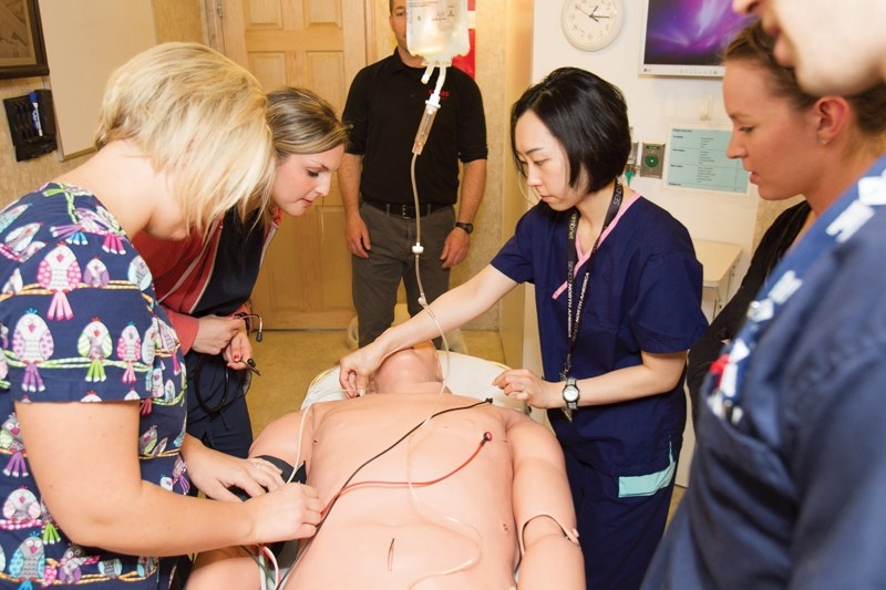 Olds Hospital and Care Centre staff (from left) Shevon Daley, Ashley Baier, Sujung Crystal Lee, Carla Olstad and Dylan Brown attend to a simulated victim during a medical