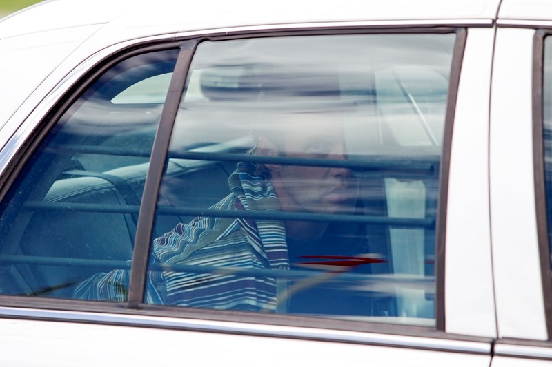 A suspect in an attempted robbery at Kelly&#8217;s Campground near Innisfail sits in the backseat of an RCMP vehicle after being apprehended on June 6 from the men&#8217;s