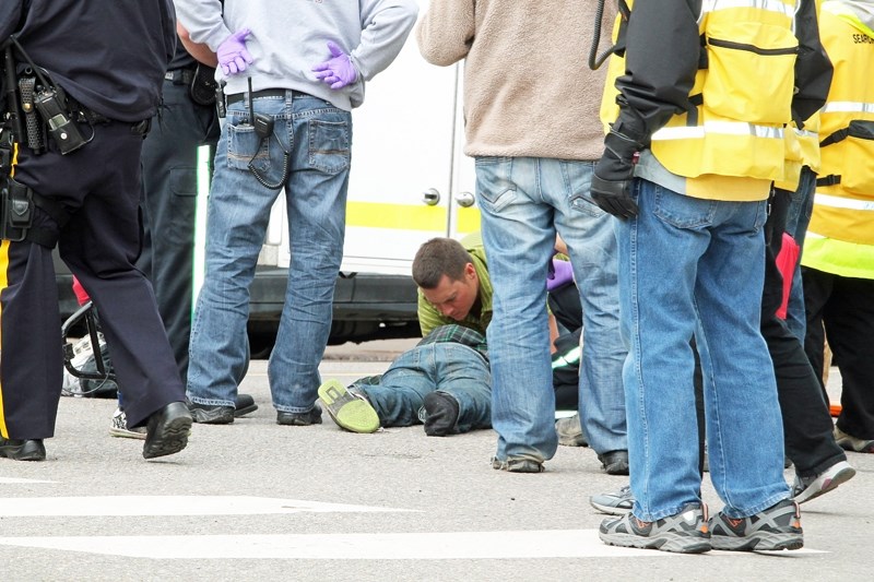 First responders tend to an eight-year-old boy who was struck by a truck while crossing the intersection of 50 Avenue and 50 Street on the morning of June 21. Police said the 