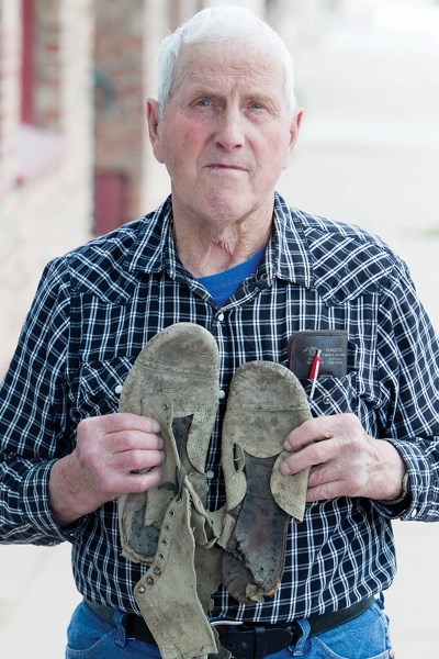 Myrle Goddard holds a pair of shoes he said his father was wearing when he was struck by lightning 90 years ago. CLICK ON PHOTO FOR LARGER IMAGE