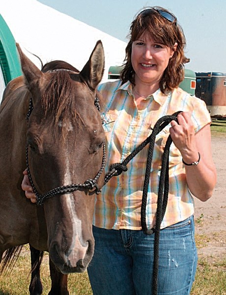 Anne Burgess, who was elected as the Olds Regional Exhibition&#8217;s first female president in May, stands with her quarter horse named Twister. CLICK ON PHOTO FOR LARGER