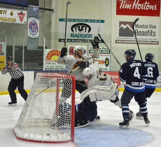 Grizzlys players celebrate after scoring a goal against the Canmore Eagles Oct. 18