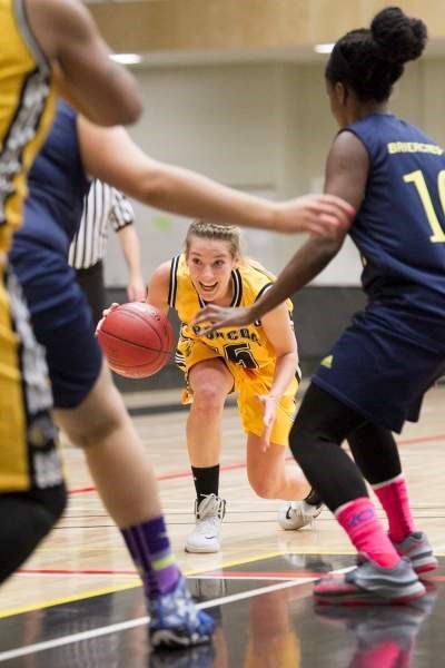 Olds College Broncos player Sierra Harty tries to break through the defence of two Briercrest College Clippers during their game at Olds College on Oct. 17.