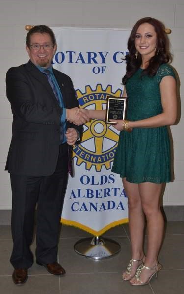 Youth Citizen of the Year Shaelyn Moritz (right) receives her award from Olds Rotary Club president Norm McInnis during the Harvest Ball Oct. 25.