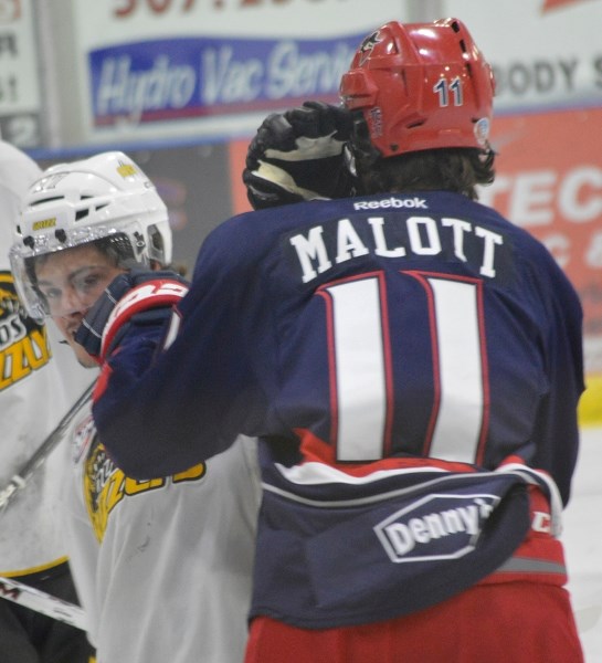 Colton Sheen, newly acquired from the Calgary Canucks, mixes it up with Brooks Bandits forward Jeff Malott during his Grizzlys debut at the Olds Sportsplex on Oct. 25.