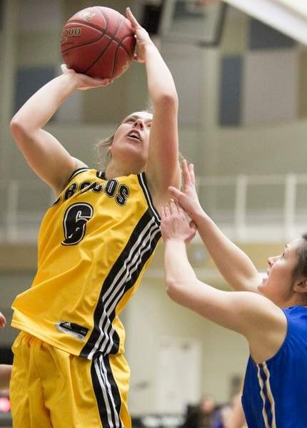 Olds College Broncos senior basketball player Mary Krause drives to the hoop during the Broncos&#8217; game against the St. Mary&#8217;s University Lightning at Olds College