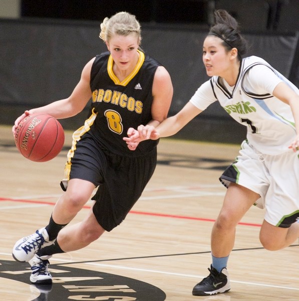 Olds College Broncos basketball player Maya Parker drives down the court during the Broncos&#8217; game against the Lethbridge College Kodiaks at Olds College on Nov. 29.