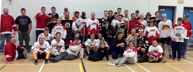 Members of the Olds and District Special Olympics team pose with members of the Olds Grizzlys Junior A hockey team. The two teams played a floor hockey game on Nov. 30.