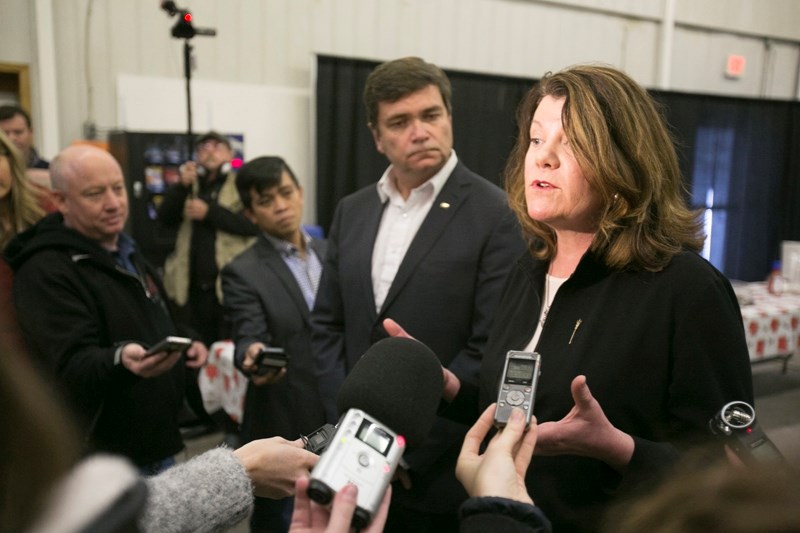 Minister of Agriculture and Forestry Oneil Carlier, left, looks on as Minister of Jobs, Skills, Training and Labour Lori Sigurdson speaks with media before the information