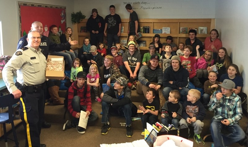 Olds RCMP officers Cpl. Shawn Morgan and Cst. Dale Bereza get ready to hand out candy canes to Bowden Grandview School students.