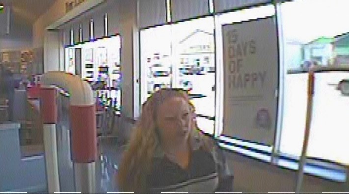 The woman in this surveillance photo is alleged to have stolen a Prada product from Shoppers Drug Mart.